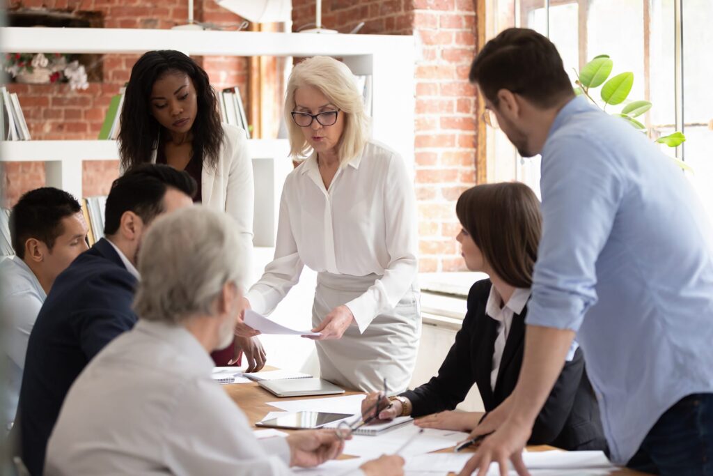 Acuity Advisors and CPAs employees sitting around conference room table discussing client tax strategies