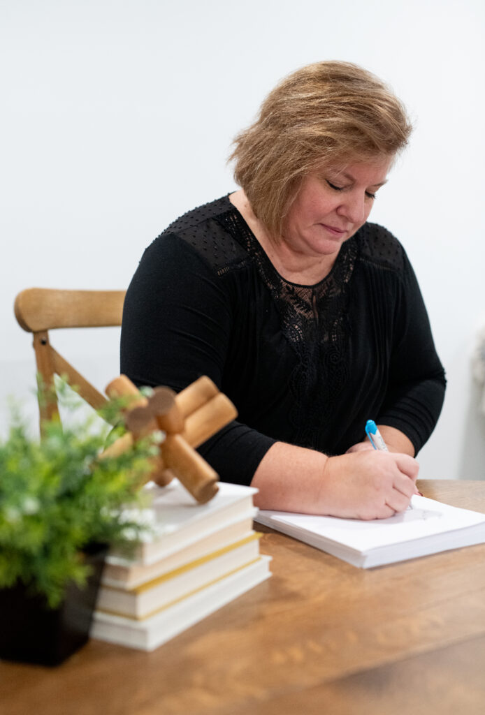 Acuity Advisors and CPAs employee analyzing paper documents on wooden table
