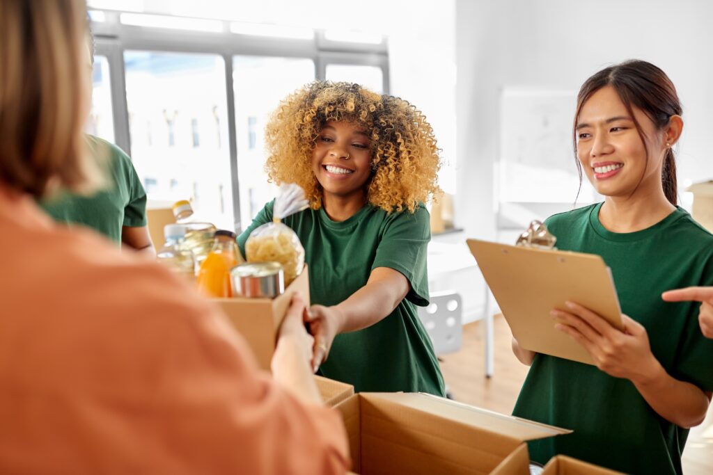 Nonprofit employees handing out boxes of food 